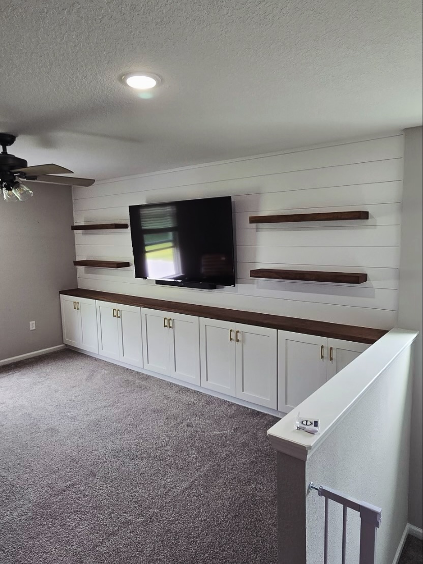 Custom living-room media wall with paneling by AVP Construction JAX — Jacksonville & St. John's County, FL