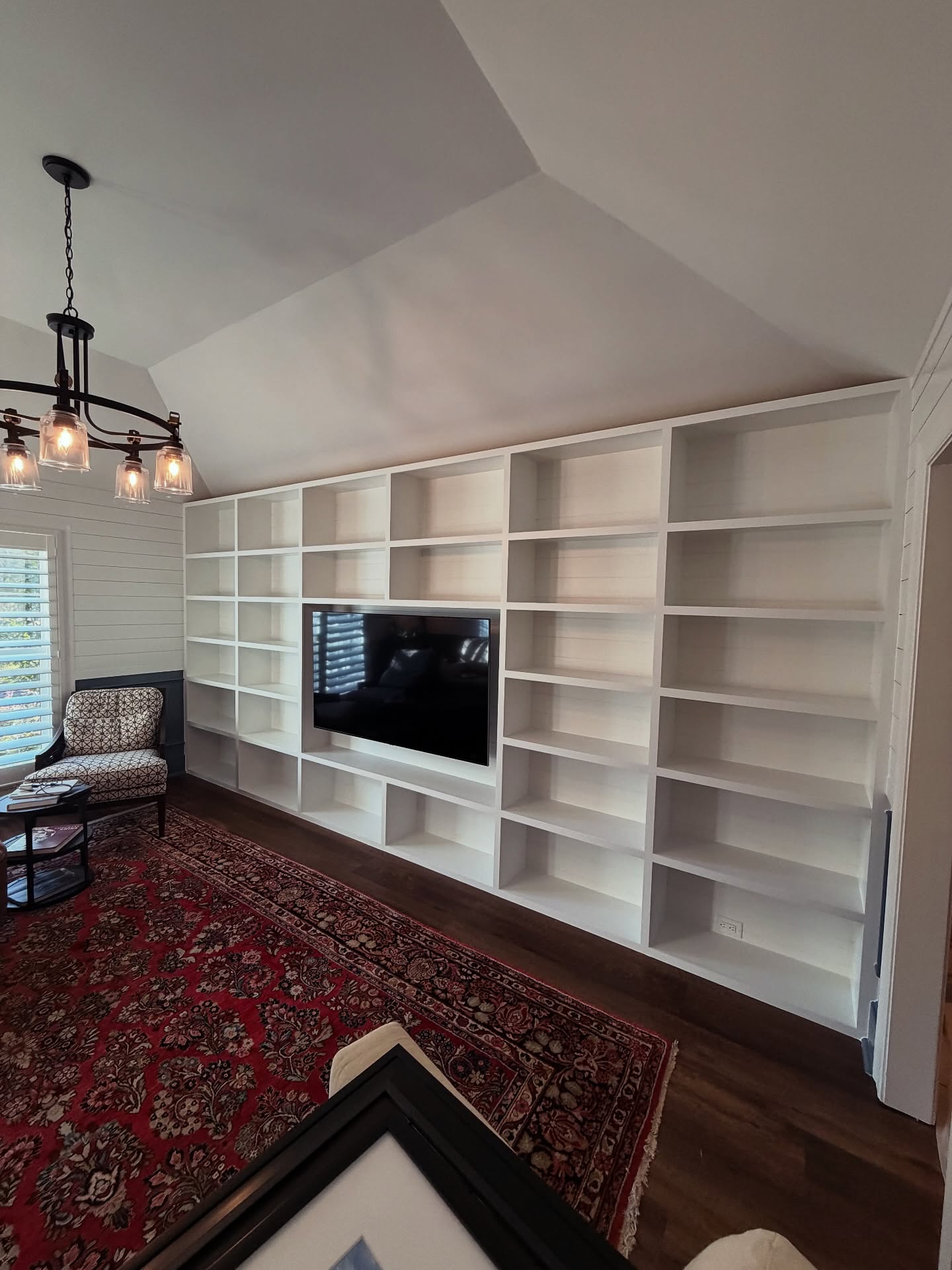 Floor-to-ceiling media wall with custom millwork by AVP Construction JAX — Jacksonville & St. John's County, FL