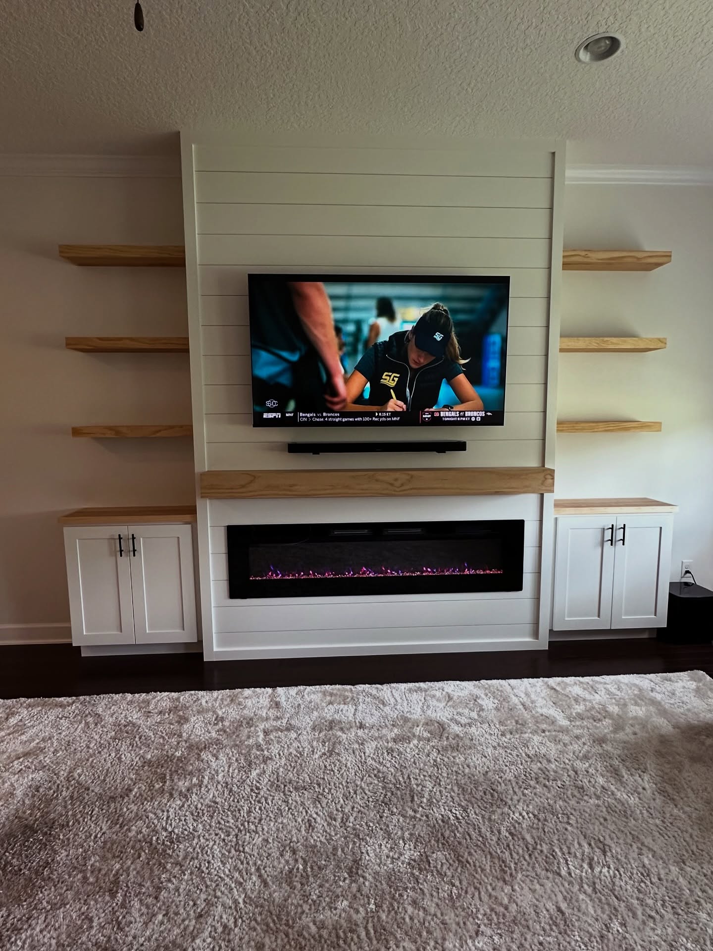 Floating-shelf TV built-in with shaker cabinets by AVP Construction JAX — Jacksonville & St. John's County, FL