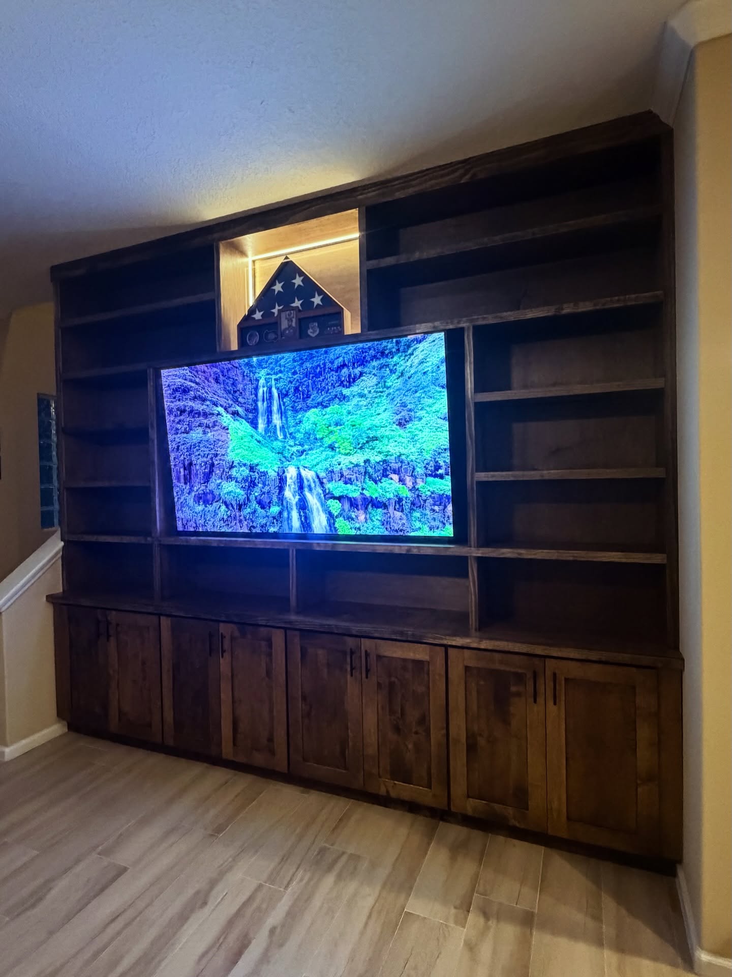 Wall-mounted TV with under-cabinet storage by AVP Construction JAX — Jacksonville & St. John's County, FL