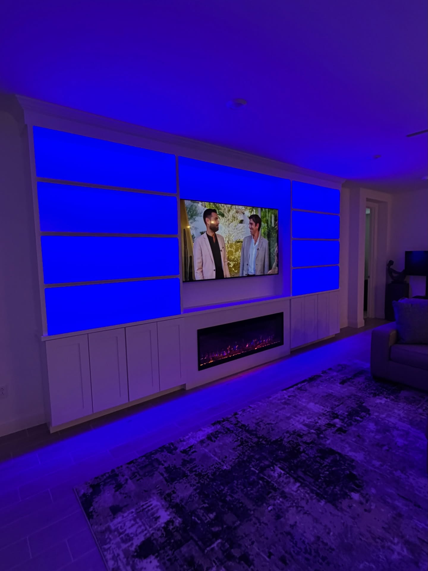 Modern entertainment center with electric fireplace by AVP Construction JAX — Jacksonville & St. John's County, FL