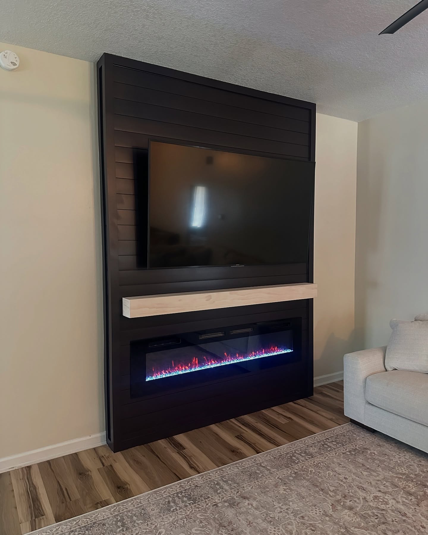 Modern entertainment center with electric fireplace by AVP Construction JAX — Jacksonville & St. John's County, FL