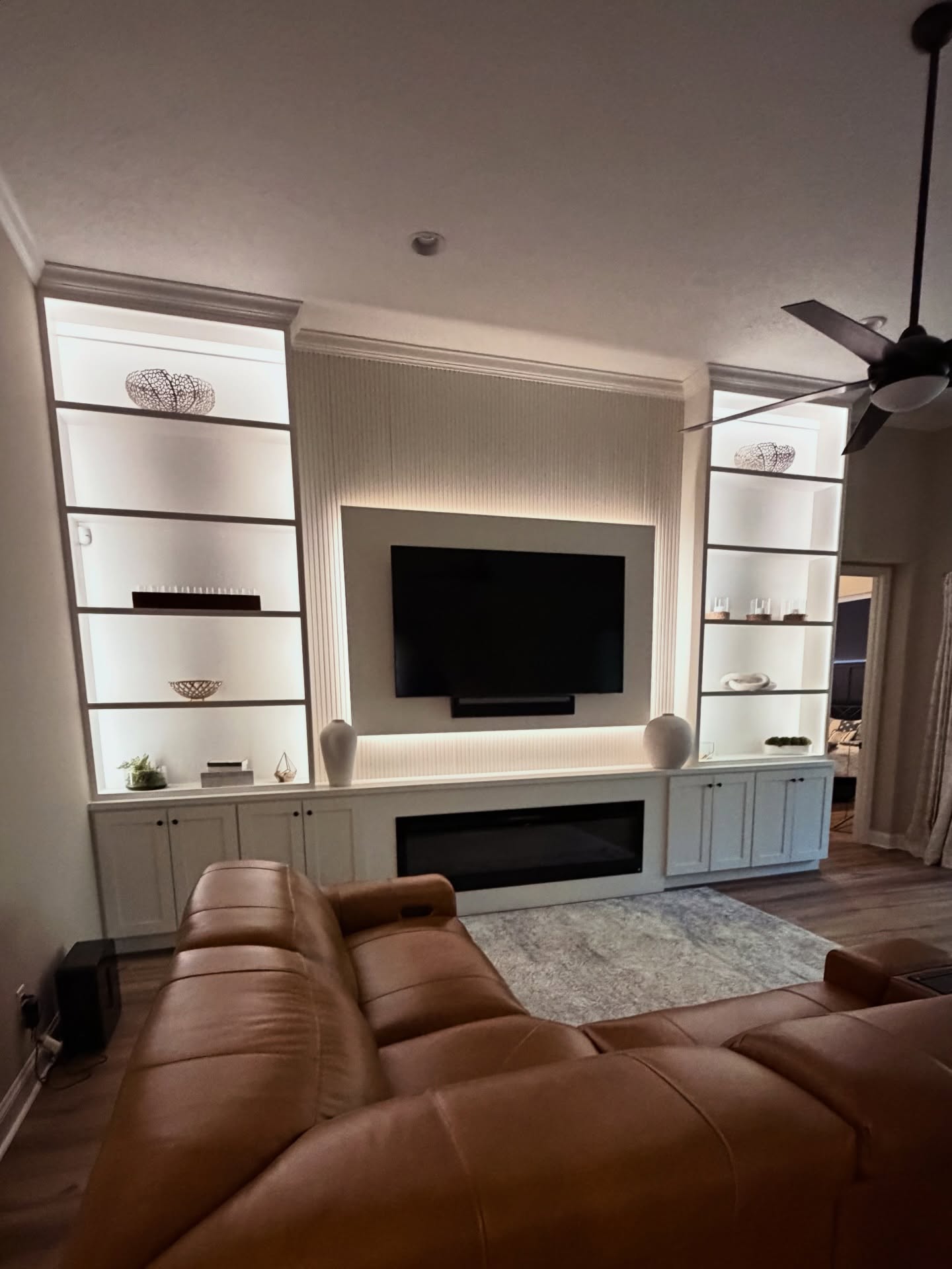 Modern entertainment center with electric fireplace by AVP Construction JAX — Jacksonville & St. John's County, FL