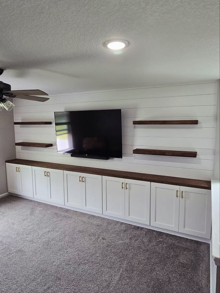 Built-in TV cabinet flanked by display shelving by AVP Construction JAX — Jacksonville & St. John's County, FL