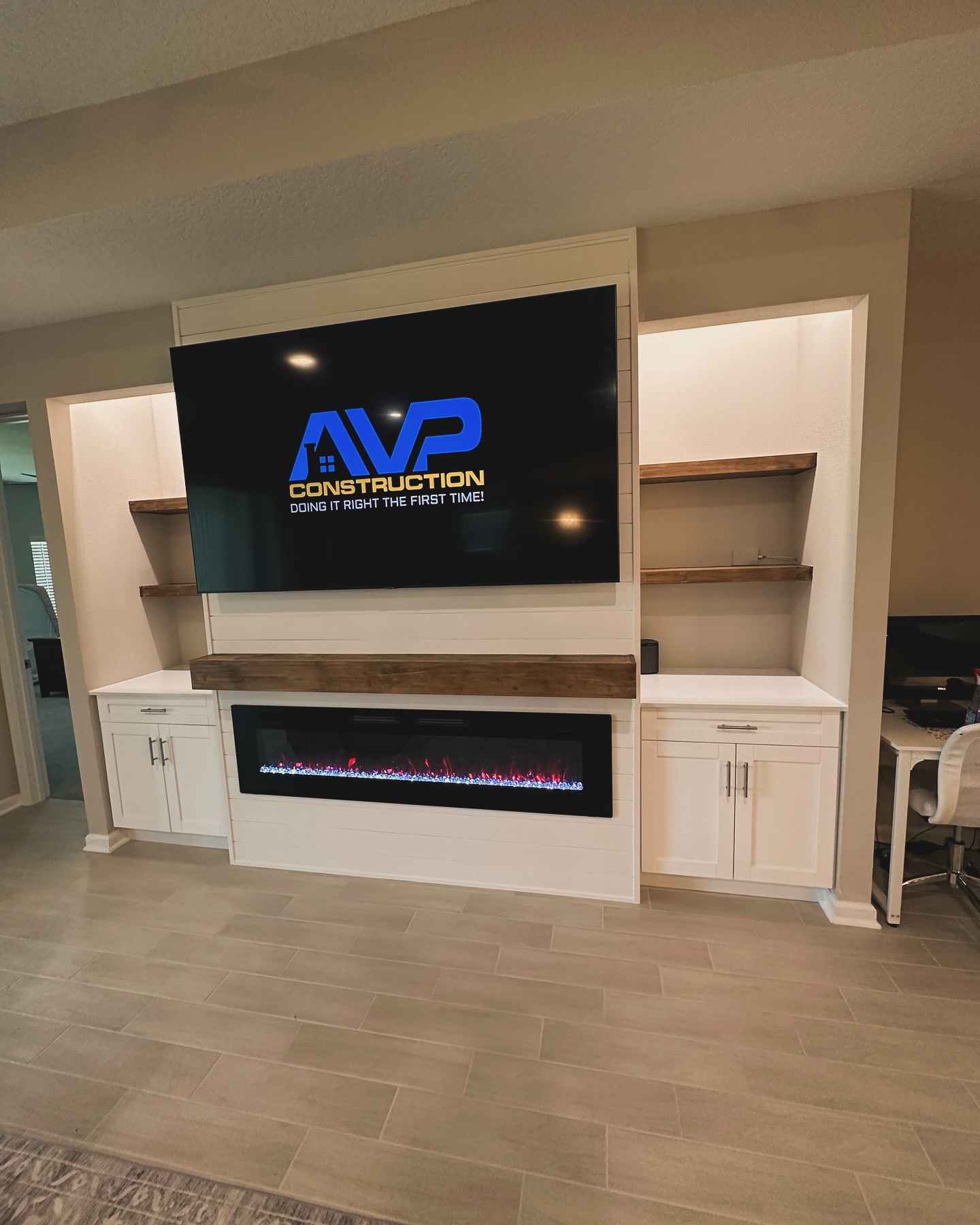 Wall-mounted TV with under-cabinet storage by AVP Construction JAX — Jacksonville & St. John's County, FL