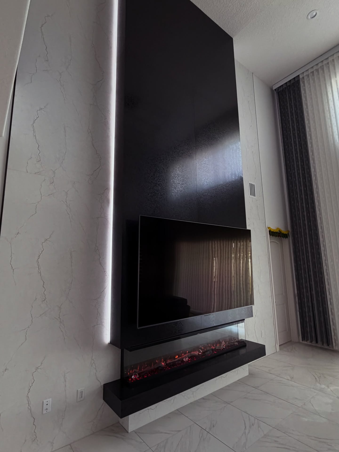 Modern entertainment center with electric fireplace by AVP Construction JAX — Jacksonville & St. John's County, FL