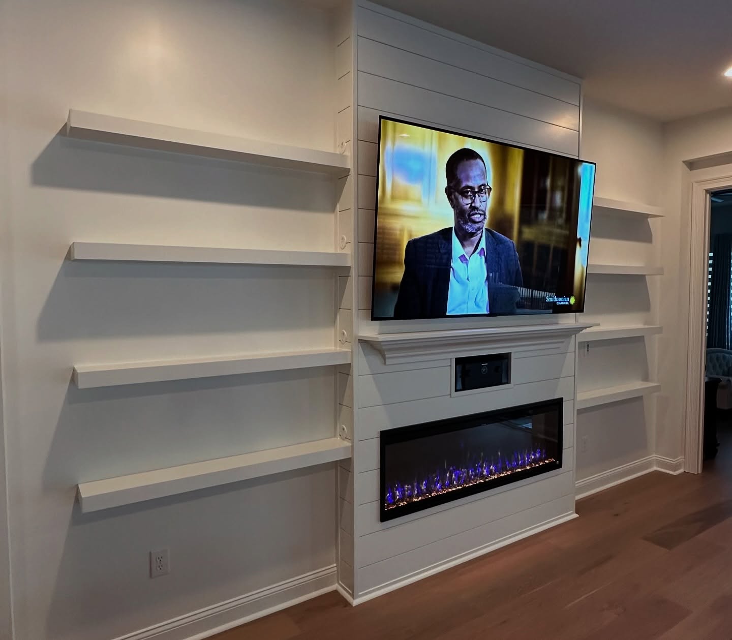Built-in TV cabinet flanked by display shelving by AVP Construction JAX — Jacksonville & St. John's County, FL