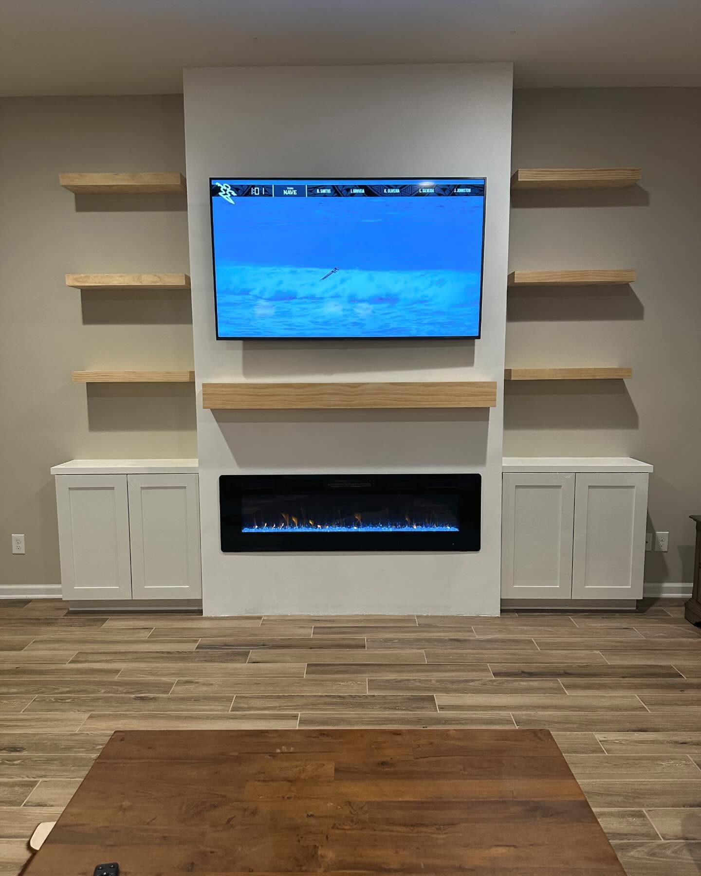 Wall-mounted TV with under-cabinet storage by AVP Construction JAX — Jacksonville & St. John's County, FL