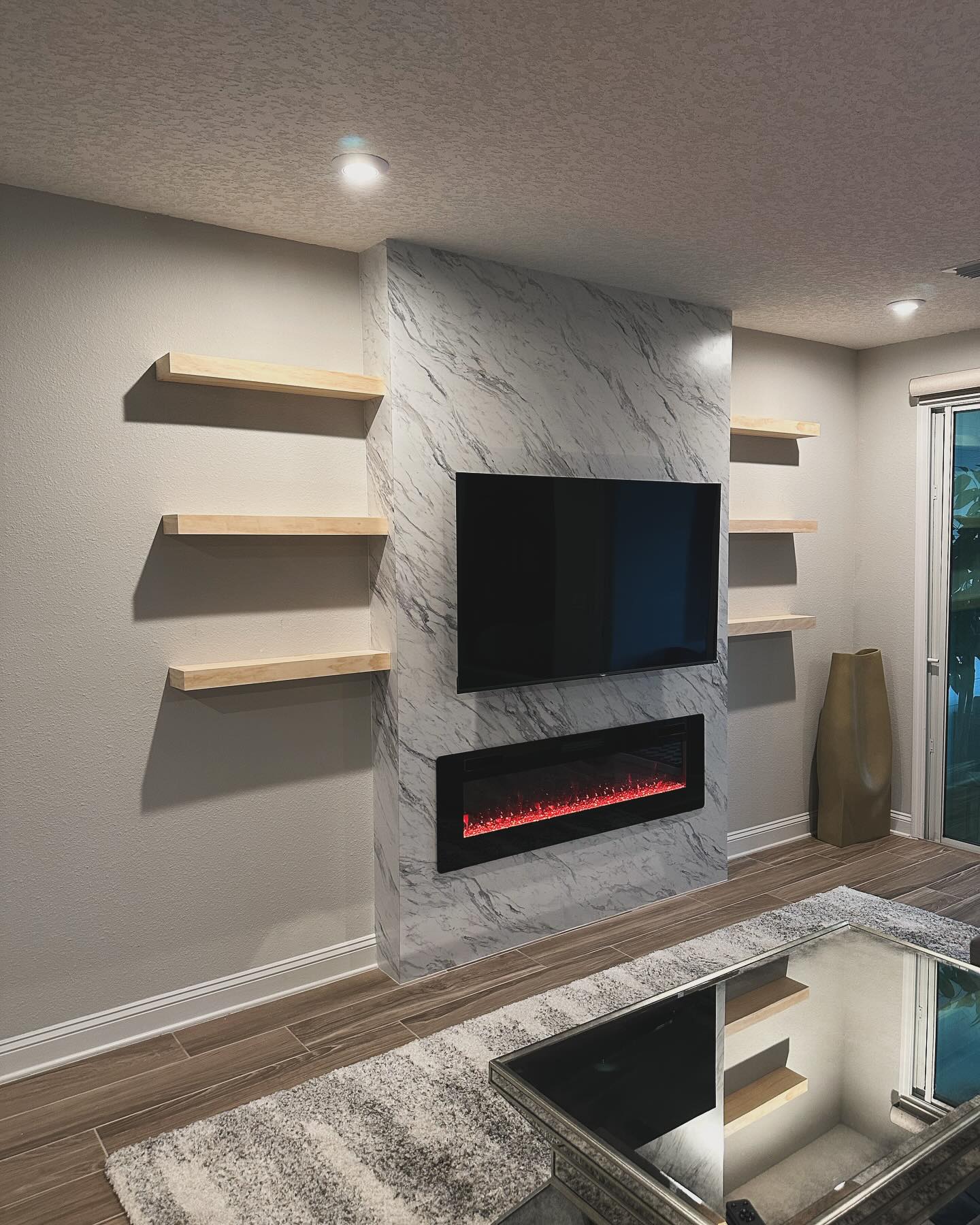 Modern entertainment center with electric fireplace by AVP Construction JAX — Jacksonville & St. John's County, FL