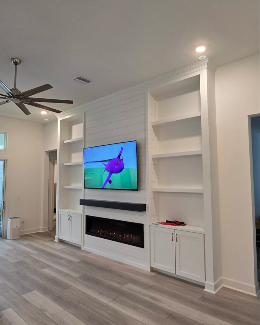 Wall-mounted TV with under-cabinet storage by AVP Construction JAX — Jacksonville & St. John's County, FL