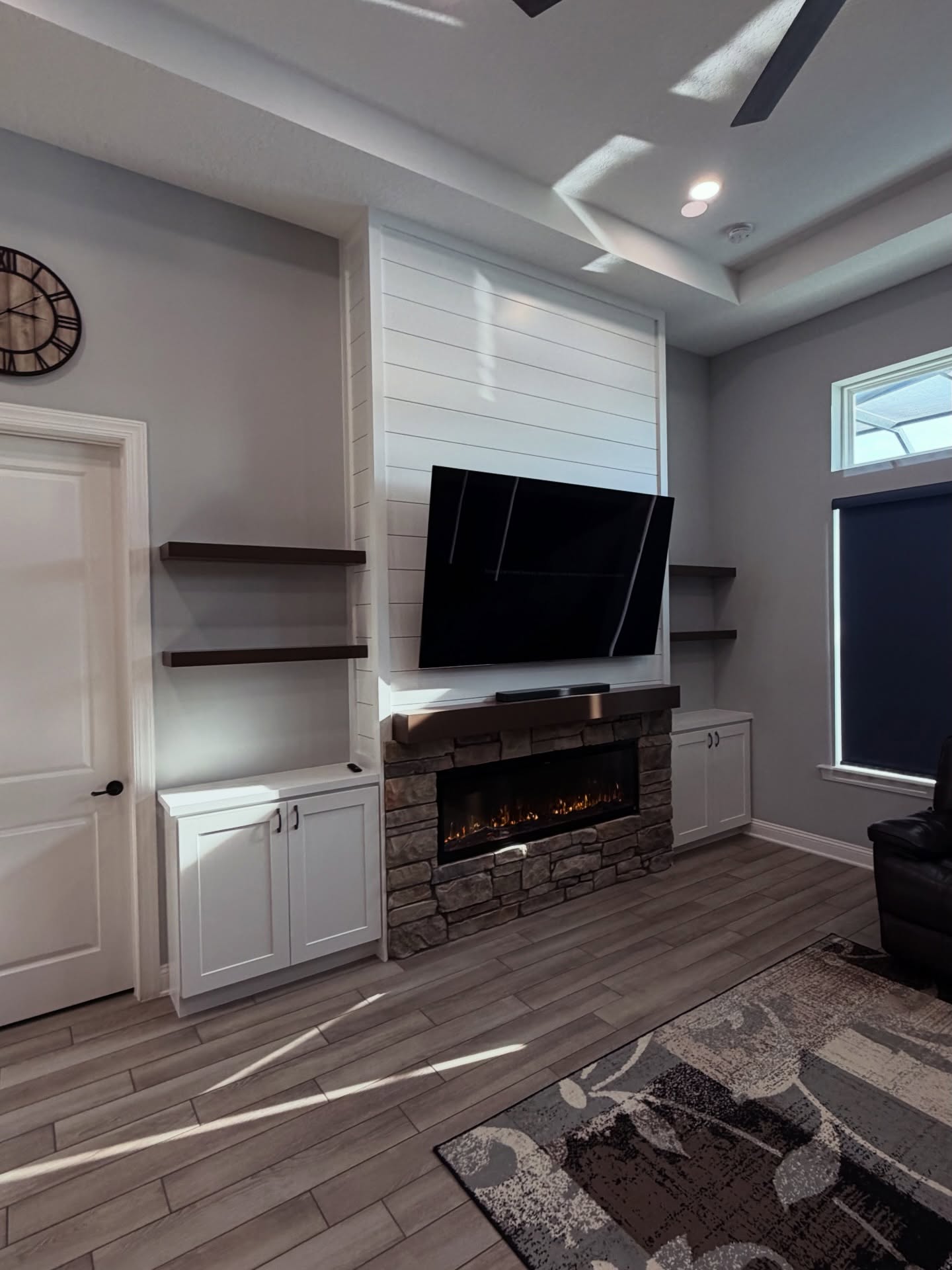 Modern entertainment center with electric fireplace by AVP Construction JAX — Jacksonville & St. John's County, FL