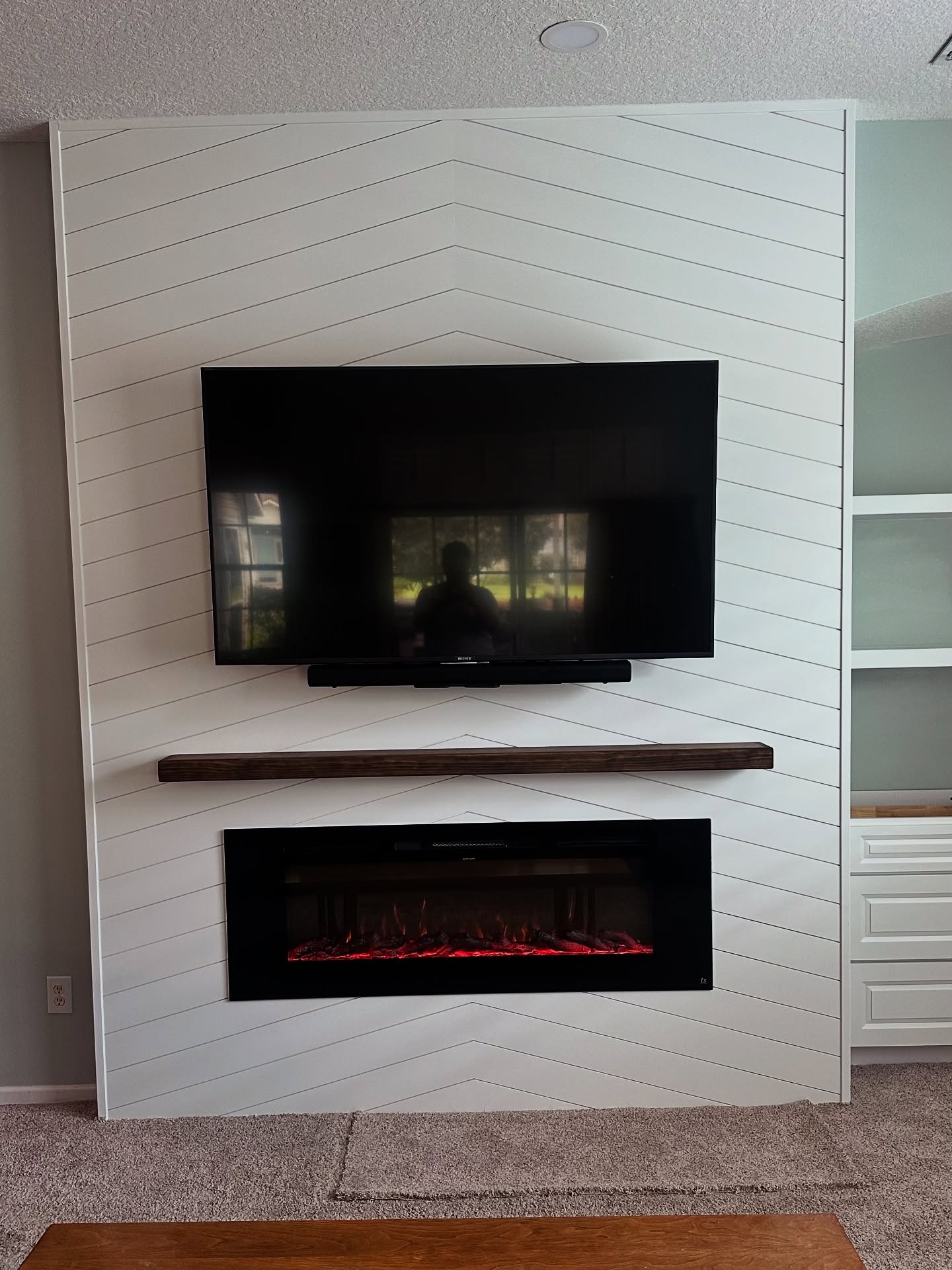 Built-in TV cabinet flanked by display shelving by AVP Construction JAX — Jacksonville & St. John's County, FL
