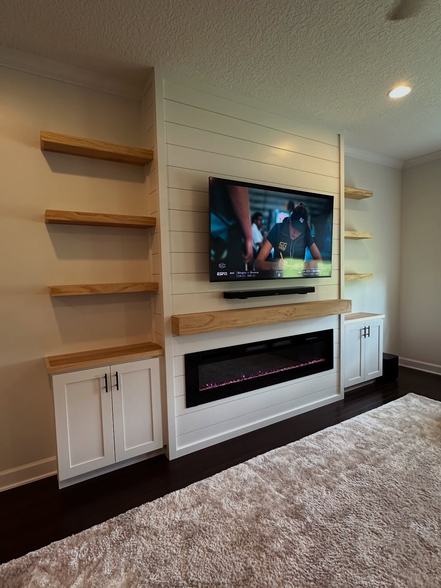 Floor-to-ceiling media wall with custom millwork by AVP Construction JAX — Jacksonville & St. John's County, FL