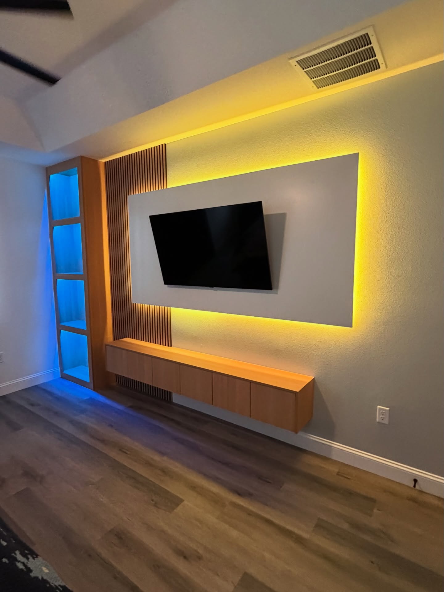 Wall-mounted TV with under-cabinet storage by AVP Construction JAX — Jacksonville & St. John's County, FL