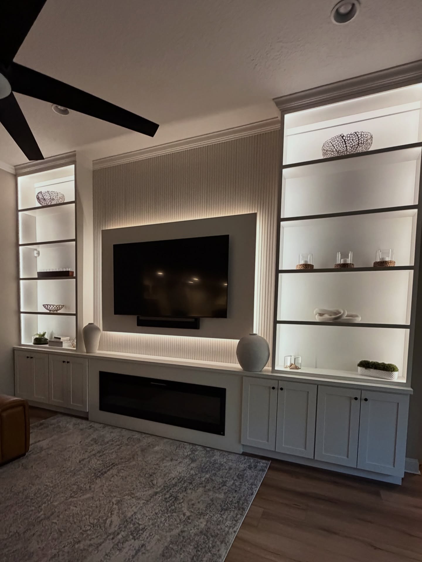 Modern entertainment center with electric fireplace by AVP Construction JAX — Jacksonville & St. John's County, FL