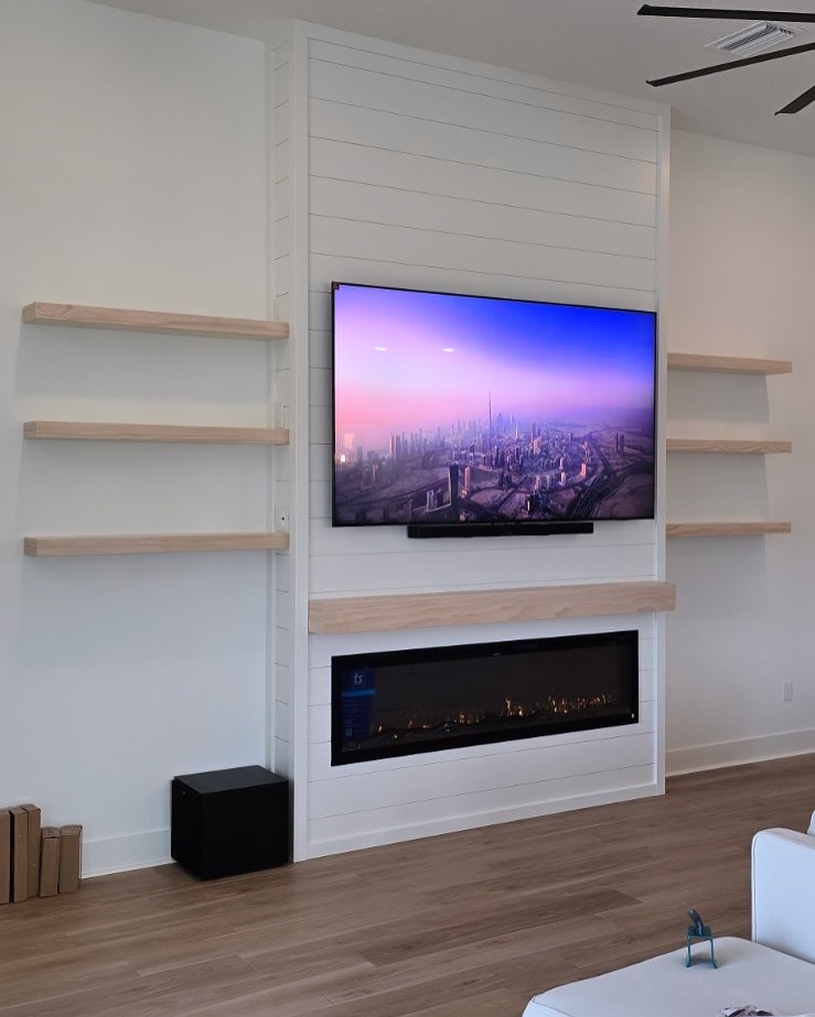 Wall-mounted TV with under-cabinet storage by AVP Construction JAX — Jacksonville & St. John's County, FL