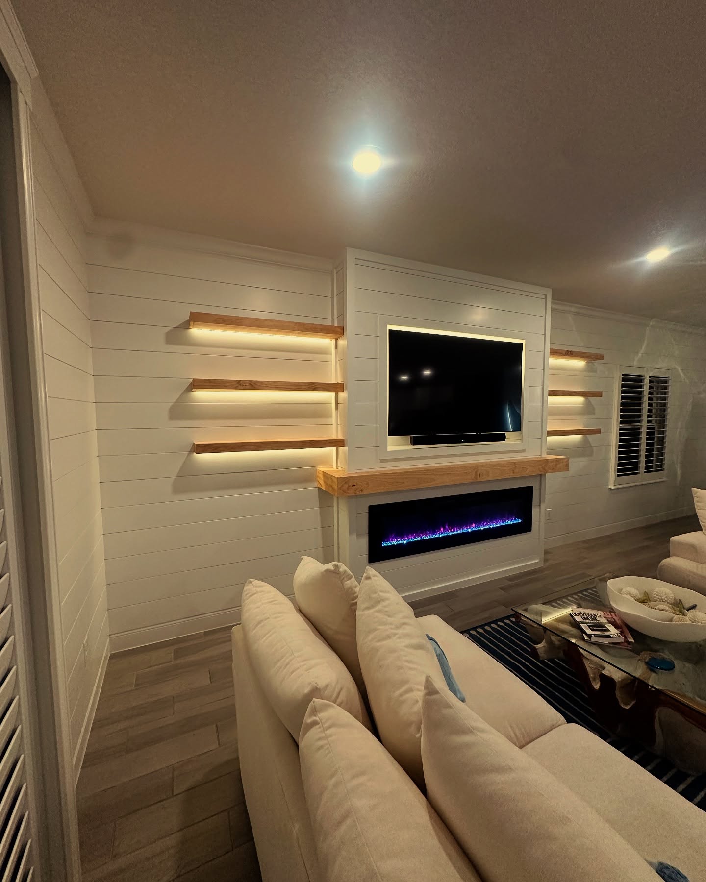 Custom living-room media wall with paneling by AVP Construction JAX — Jacksonville & St. John's County, FL