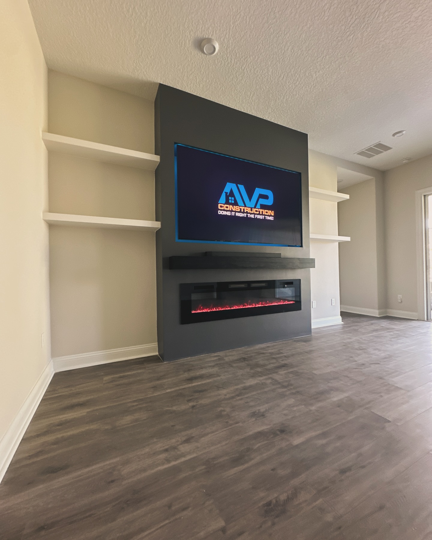 Floating-shelf TV built-in with shaker cabinets by AVP Construction JAX — Jacksonville & St. John's County, FL
