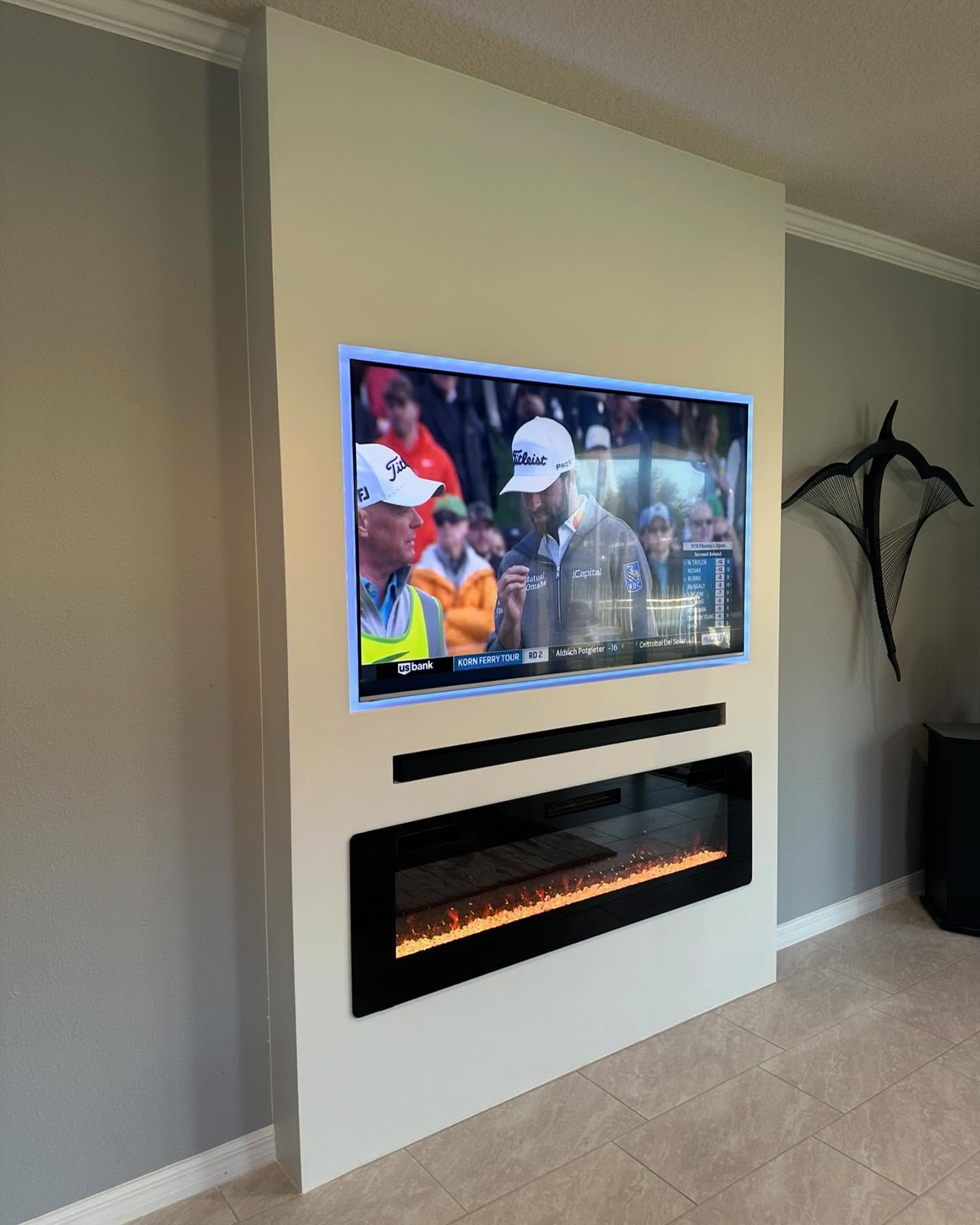Wall-mounted TV with under-cabinet storage by AVP Construction JAX — Jacksonville & St. John's County, FL