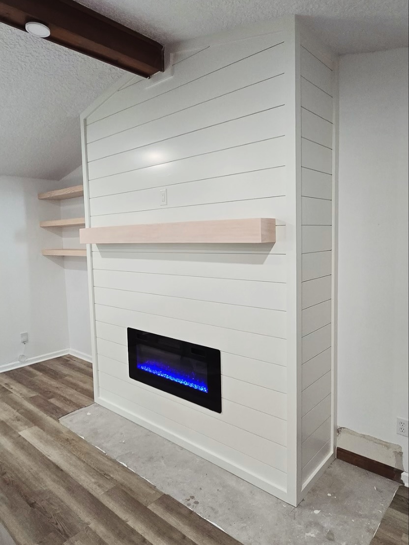 Wall-mounted TV with under-cabinet storage by AVP Construction JAX — Jacksonville & St. John's County, FL