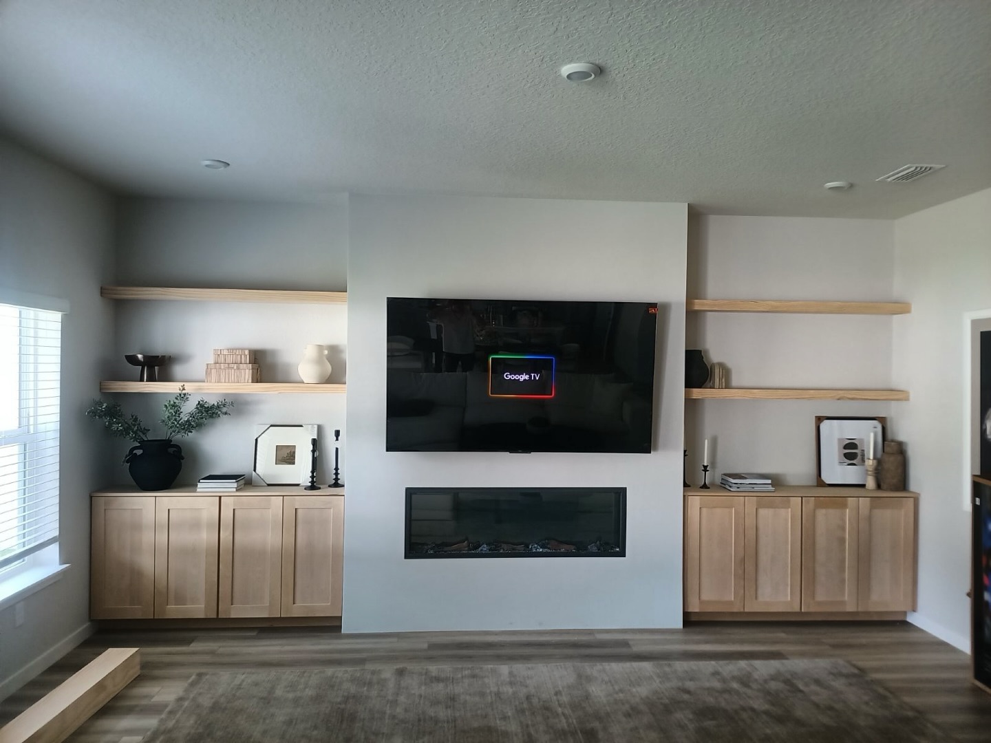 Floating-shelf TV built-in with shaker cabinets by AVP Construction JAX — Jacksonville & St. John's County, FL