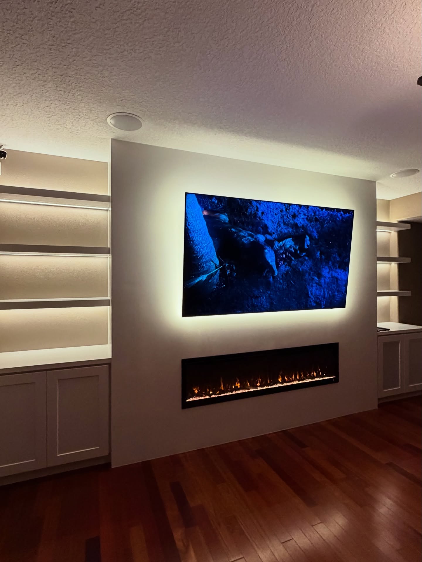 Modern entertainment center with electric fireplace by AVP Construction JAX — Jacksonville & St. John's County, FL