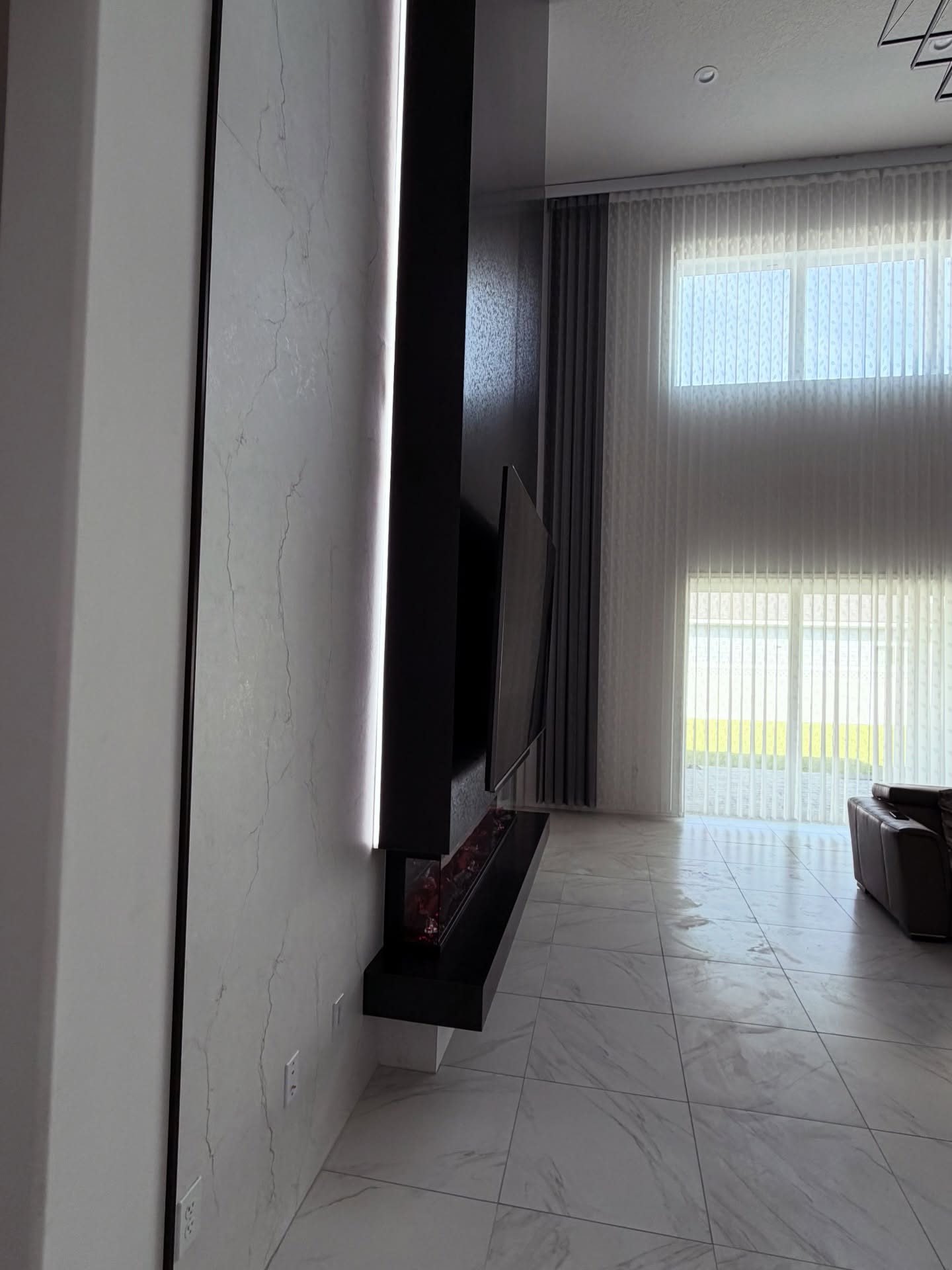 Modern entertainment center with electric fireplace by AVP Construction JAX — Jacksonville & St. John's County, FL