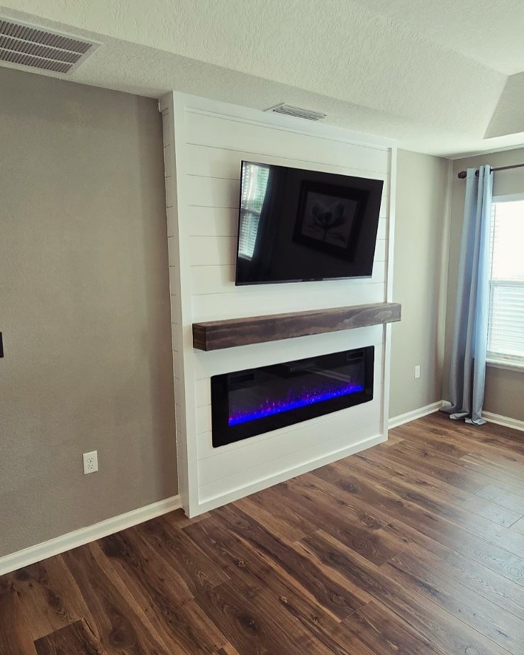 Built-in TV cabinet flanked by display shelving by AVP Construction JAX — Jacksonville & St. John's County, FL