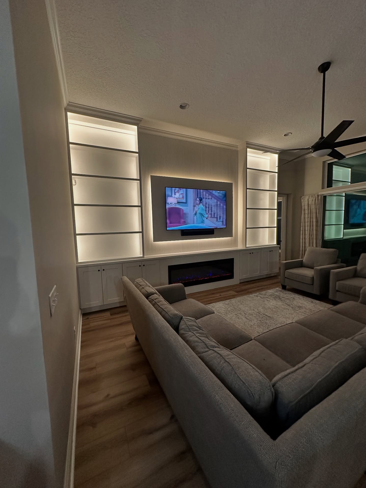 Floor-to-ceiling media wall with custom millwork by AVP Construction JAX — Jacksonville & St. John's County, FL