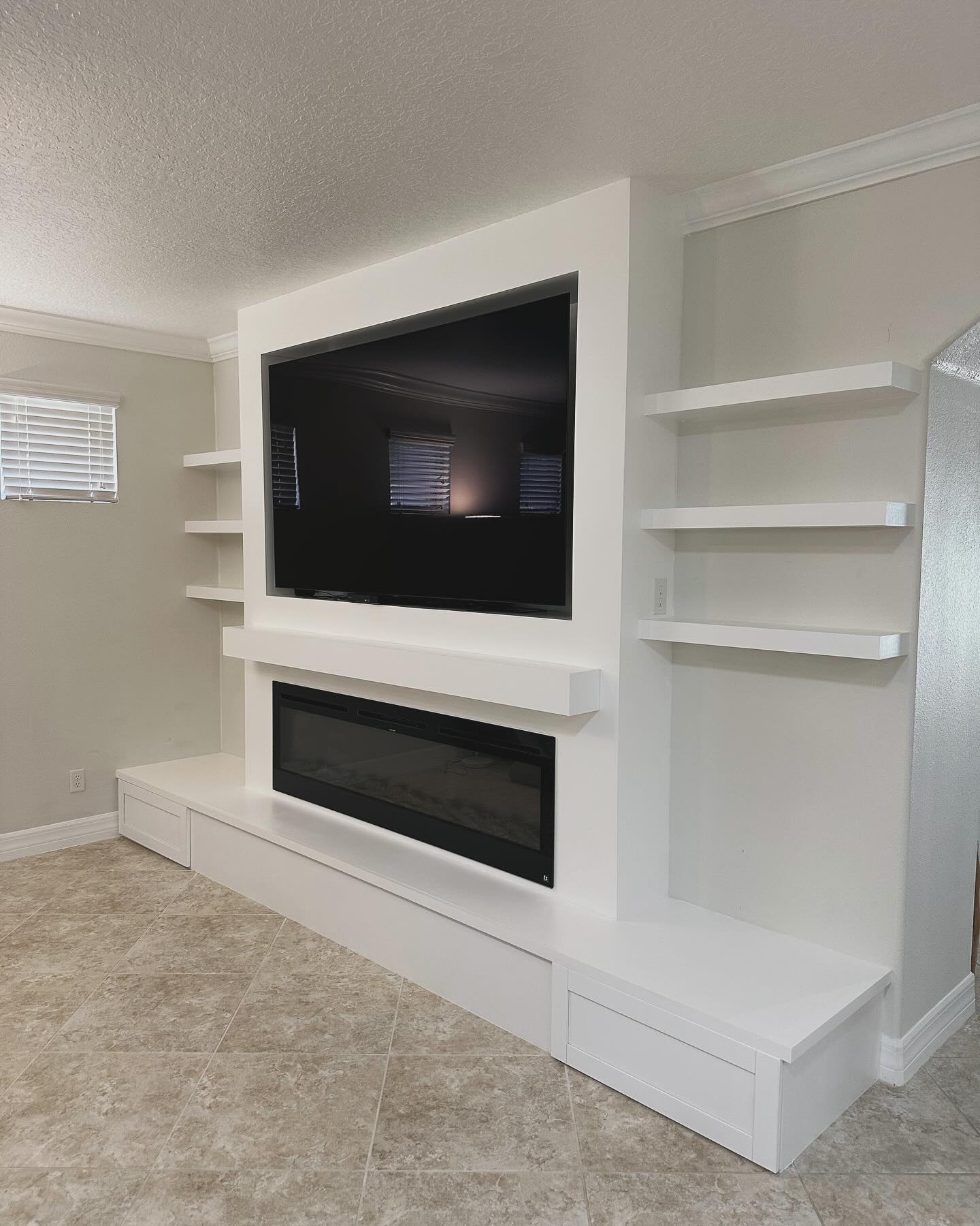 Built-in TV cabinet flanked by display shelving by AVP Construction JAX — Jacksonville & St. John's County, FL